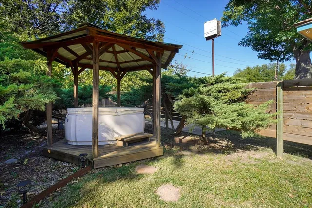 a view of a patio with table and chairs under an umbrella