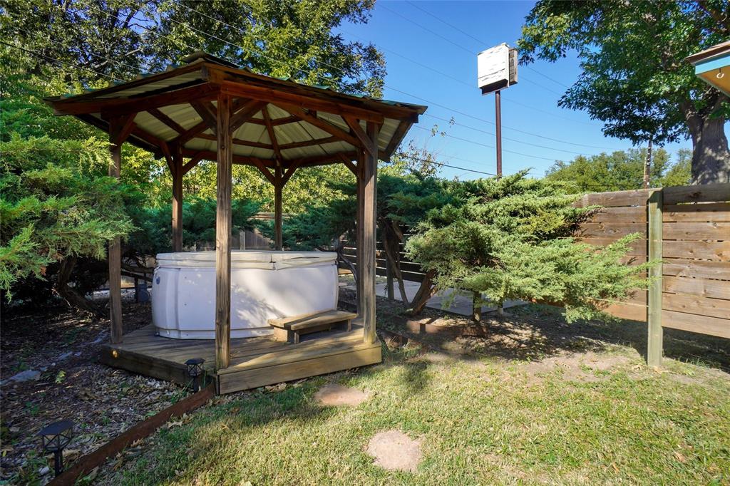 2109 Malone Street Denton, TX 76201 - Photo 26 of 36 a view of a patio with table and chairs under an umbrella