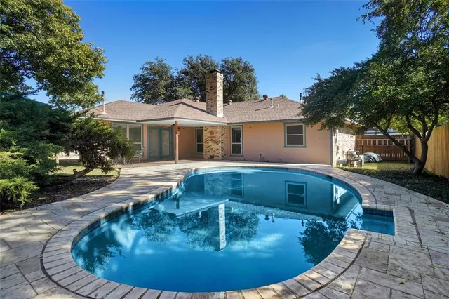 a view of a swimming pool with a sitting area