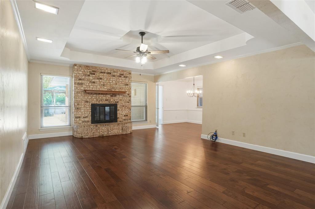 2109 Malone Street Denton, TX 76201 - Photo 9 of 36 an empty room with wooden floor fireplace and windows