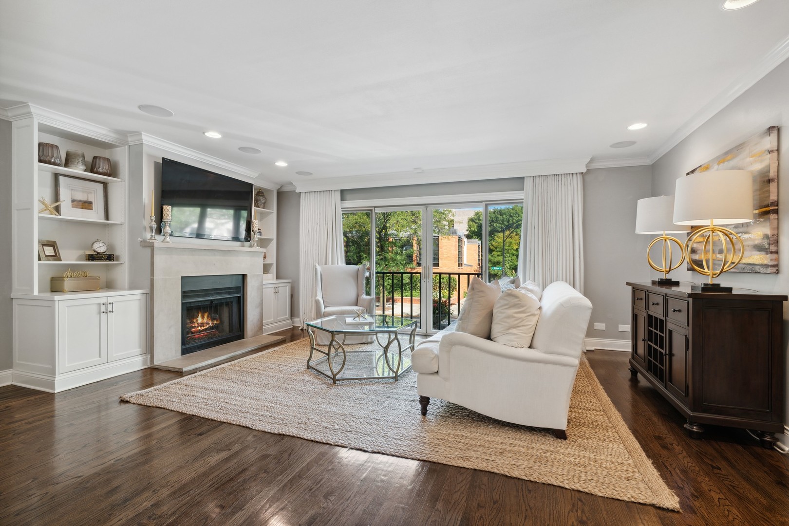 641 West Willow Street, Unit 105 Chicago, IL 60614 - Photo 2 of 37 a living room with furniture flat screen tv and a fireplace