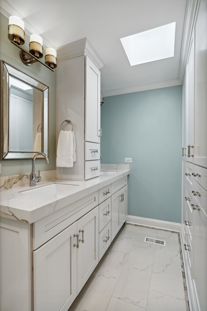 641 West Willow Street, Unit 105 Chicago, IL 60614 - Photo 21 of 37 a bathroom with a double vanity sink and a mirror