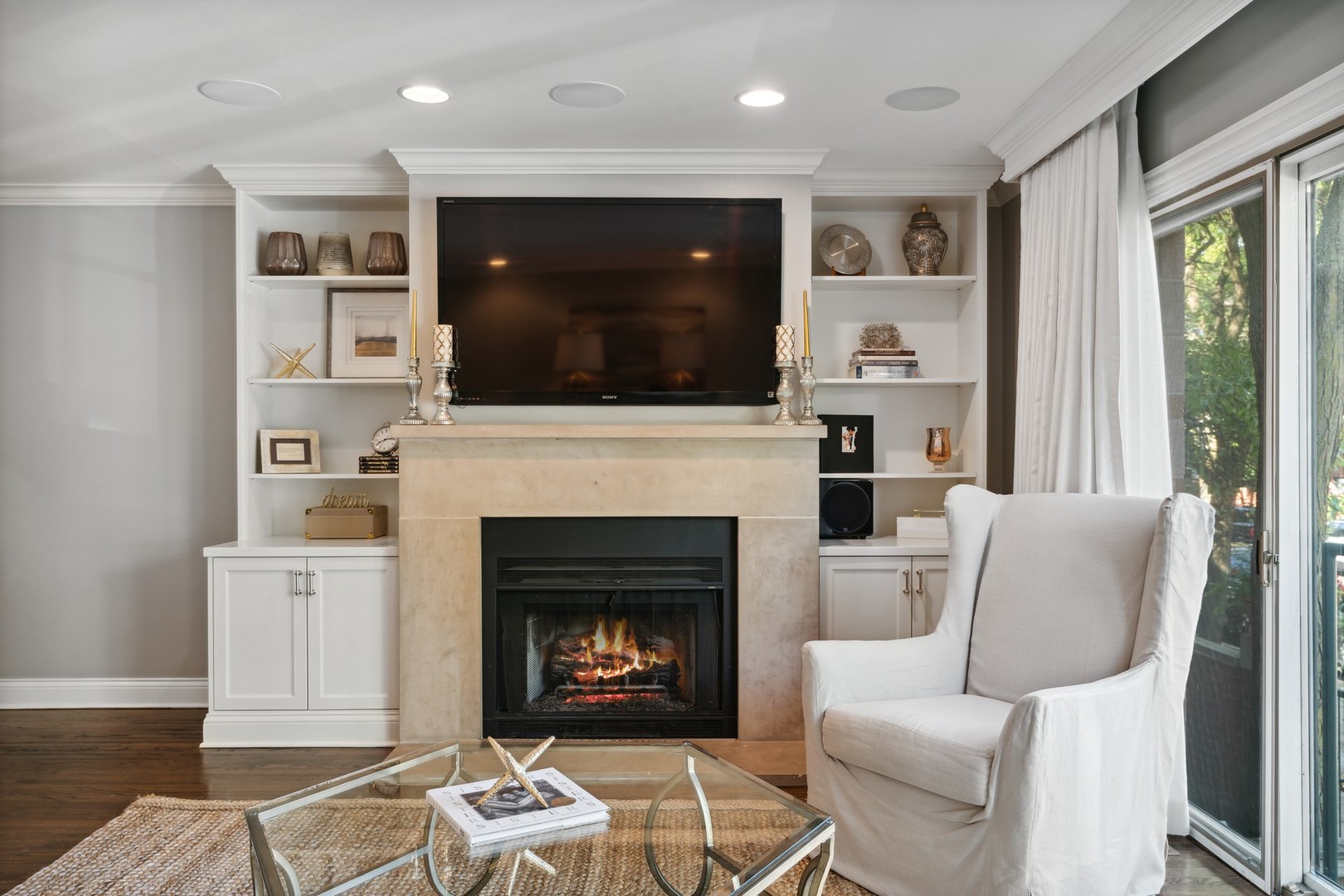 641 West Willow Street, Unit 105 Chicago, IL 60614 - Photo 4 of 37 a living room with furniture a flat screen tv and a fireplace