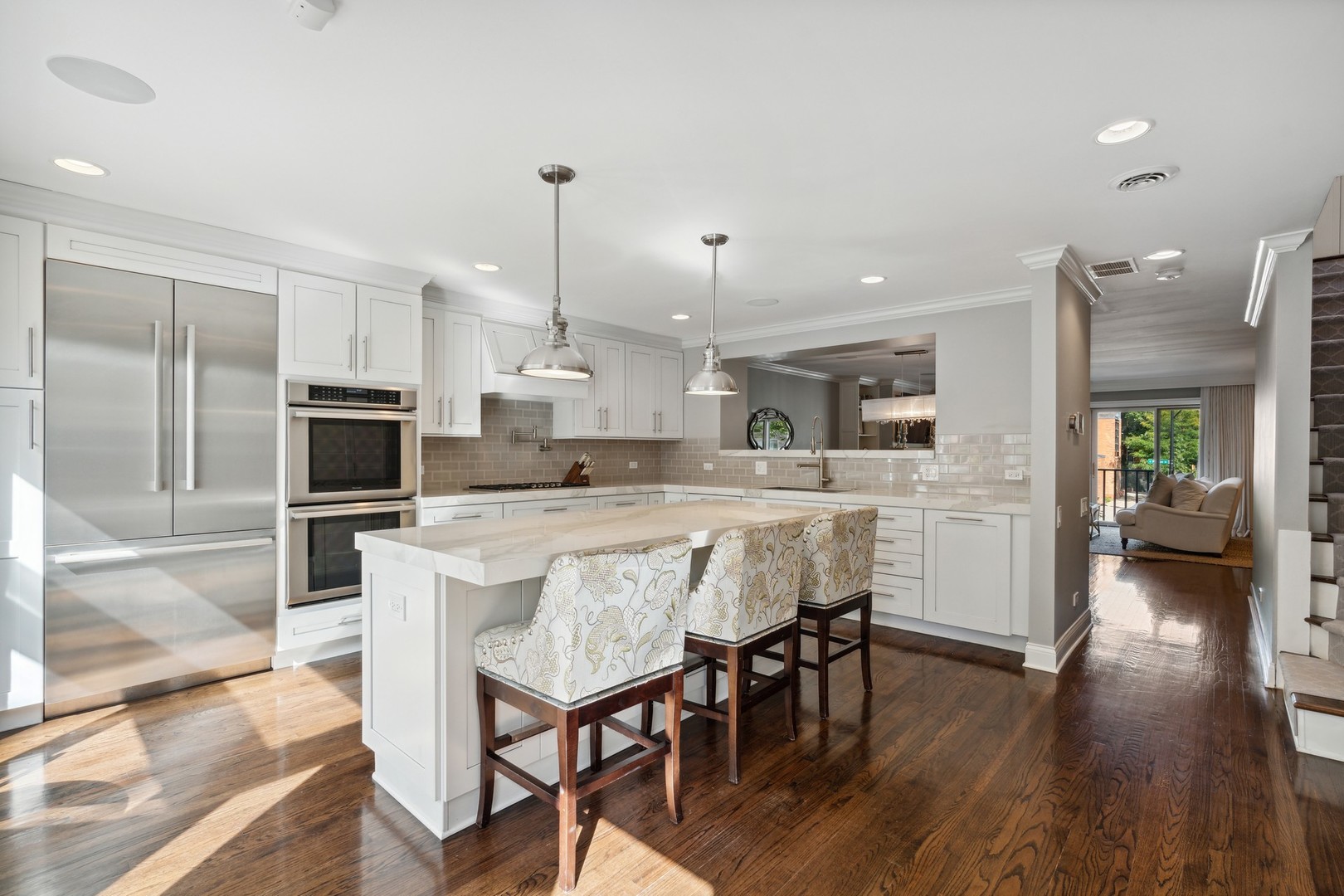 641 West Willow Street, Unit 105 Chicago, IL 60614 - Photo 8 of 37 a kitchen with stainless steel appliances kitchen island granite countertop a table chairs sink and cabinets