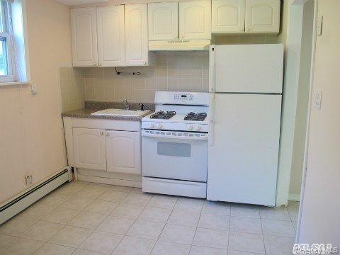 5 Elm Street Great Neck, NY 11021 - Photo 8 of 17 a utility room with dryer and washer