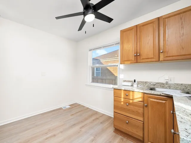 a kitchen with granite countertop cabinets stainless steel appliances and a sink