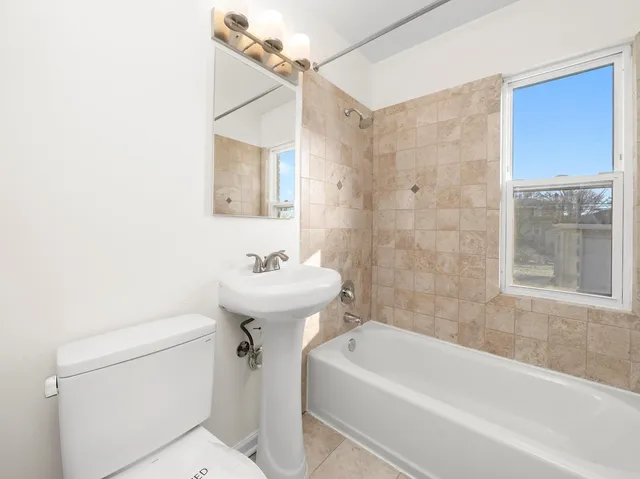 a bathroom with a sink a toilet and bathtub