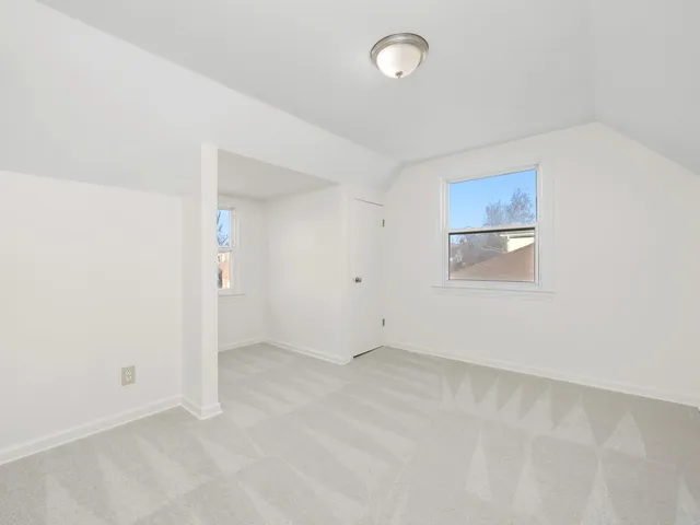 an empty room with a empty space and windows