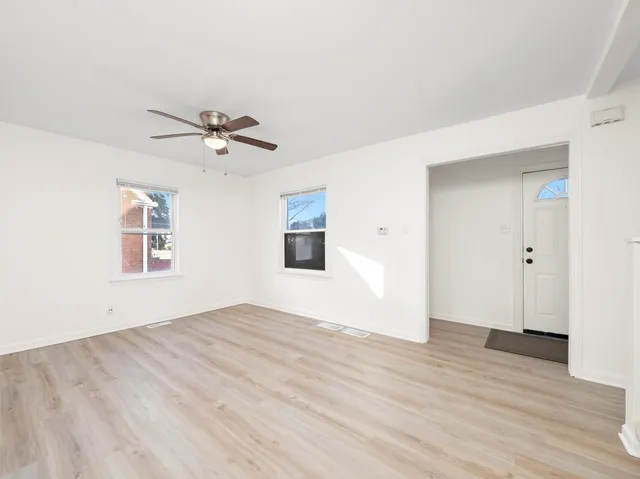 a view of an empty room with wooden floor