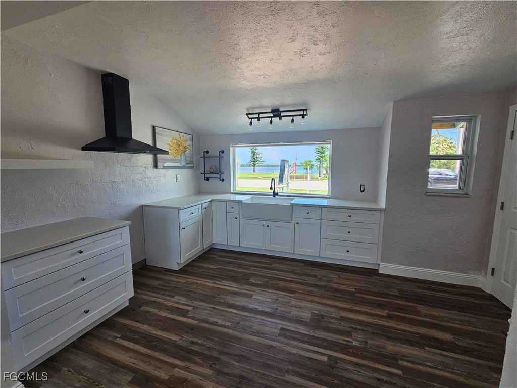 4673 Pine Island Road Matlacha, FL 33993 - Photo 11 of 29 a kitchen with granite countertop a stove cabinets and wooden floor