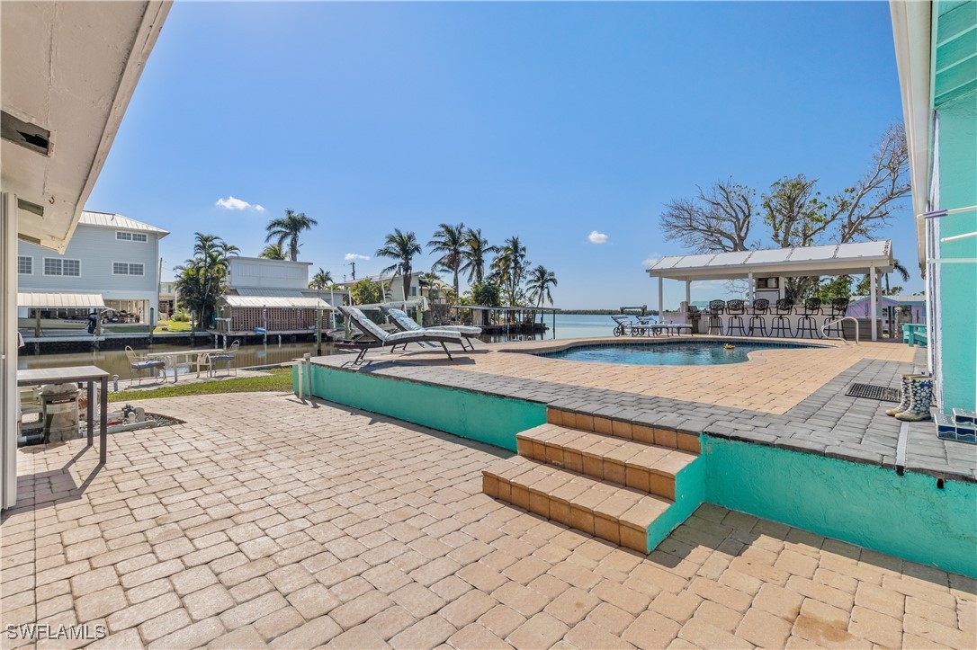 4673 Pine Island Road Matlacha, FL 33993 - Photo 2 of 29 a swimming pool with outdoor seating and yard