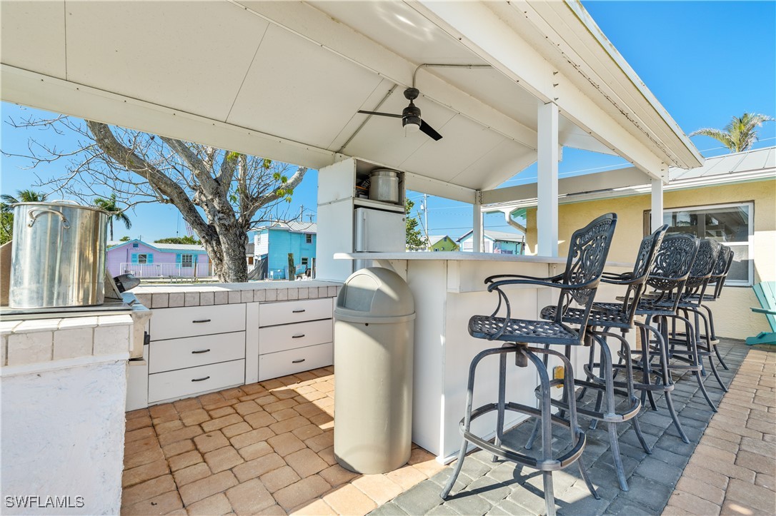 4673 Pine Island Road Matlacha, FL 33993 - Photo 4 of 29 a kitchen with stainless steel appliances kitchen island granite countertop a table and chairs in it