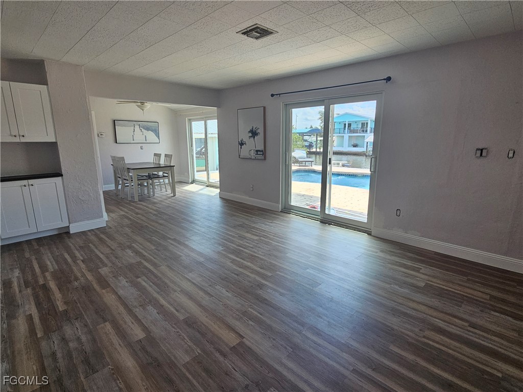4673 Pine Island Road Matlacha, FL 33993 - Photo 7 of 29 a view of an empty room with wooden floor and a window