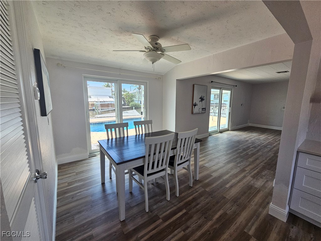 4673 Pine Island Road Matlacha, FL 33993 - Photo 9 of 29 a view of a dining room with furniture window and wooden floor