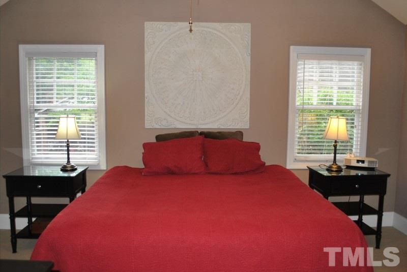 1512 Fairview Road Raleigh, NC 27608 - Photo 14 of 25 a bedroom with a bed and a table