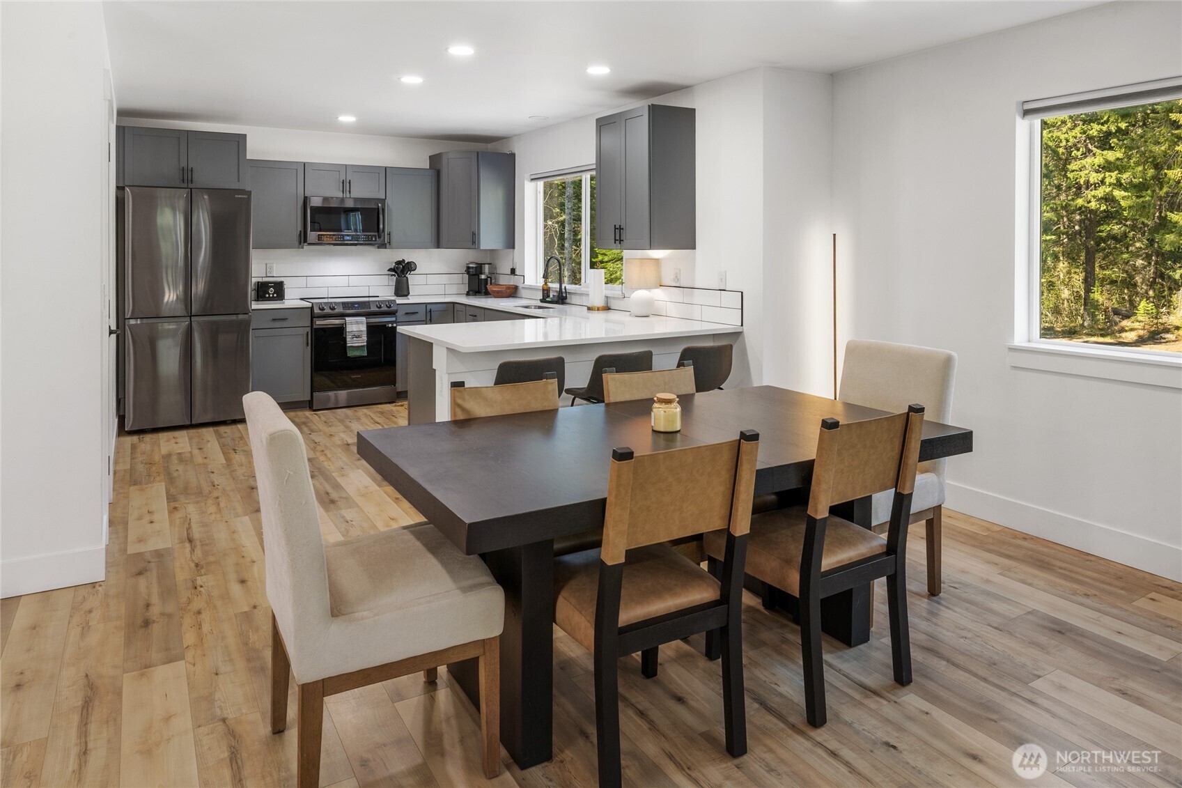 630 Silver Creek Road Easton, WA 98925 - Photo 14 of 40 a dining room with stainless steel appliances kitchen island granite countertop a dining table chairs and a refrigerator