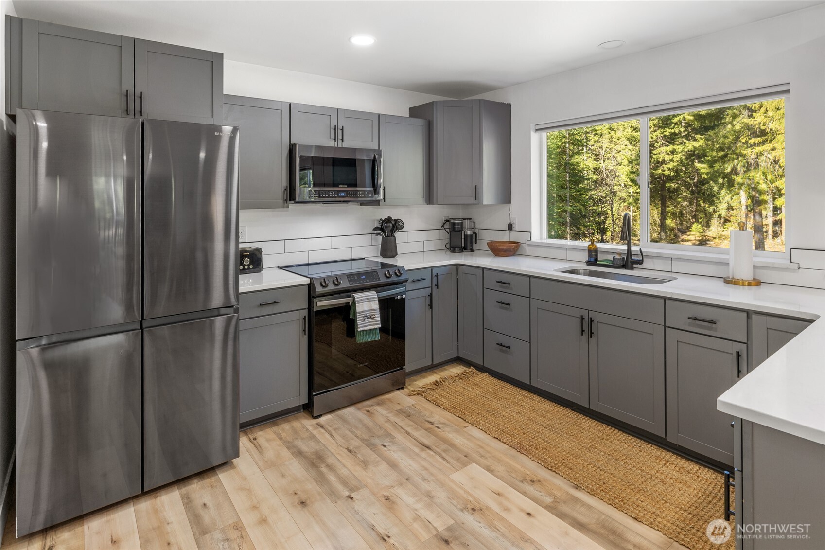 630 Silver Creek Road Easton, WA 98925 - Photo 16 of 40 a kitchen with stainless steel appliances granite countertop a refrigerator sink stove microwave and cabinets