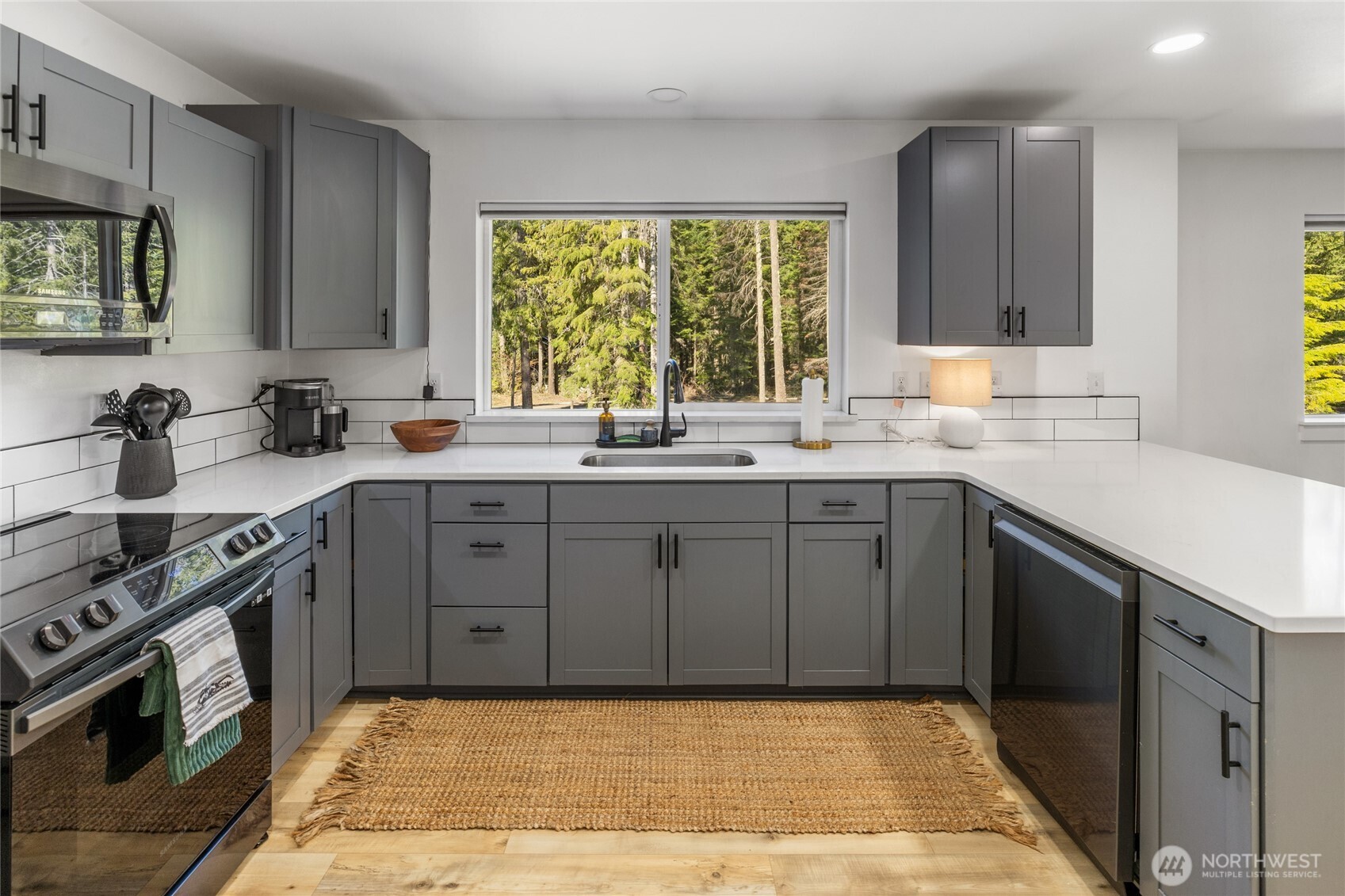 630 Silver Creek Road Easton, WA 98925 - Photo 17 of 40 a kitchen with a sink stove and cabinets