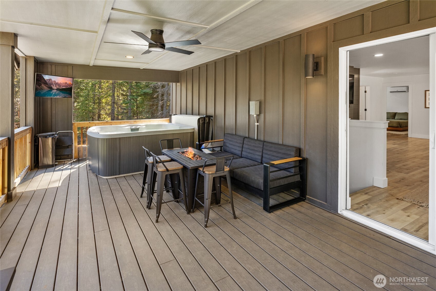 630 Silver Creek Road Easton, WA 98925 - Photo 27 of 40 a view of a patio with table and chairs with wooden floor and floor to ceiling window