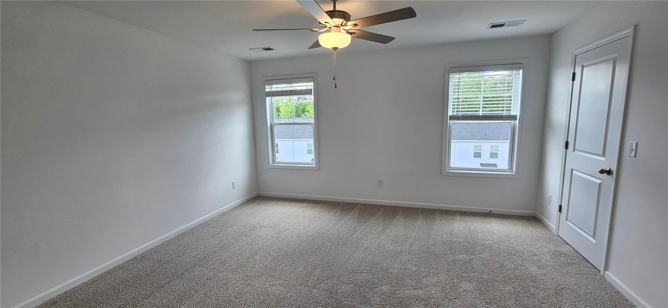 409 Belgrove Way Easley, SC 29640 - Photo 8 of 15 This spacious room features ample natural light and plush carpet flooring, ready for personalization.