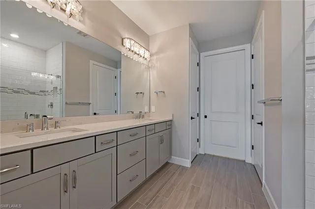 a spacious bathroom with a double vanity sink double and mirror