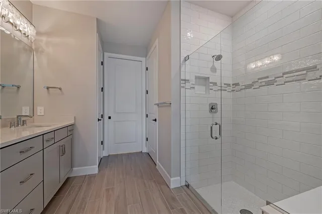a bathroom with a shower sink and mirror