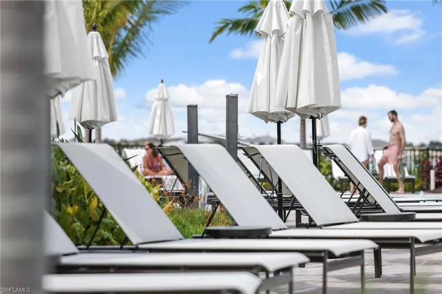 a view of balcony with chairs and a potted plant