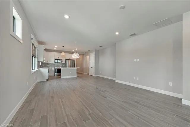 a view of kitchen with furniture and wooden floor