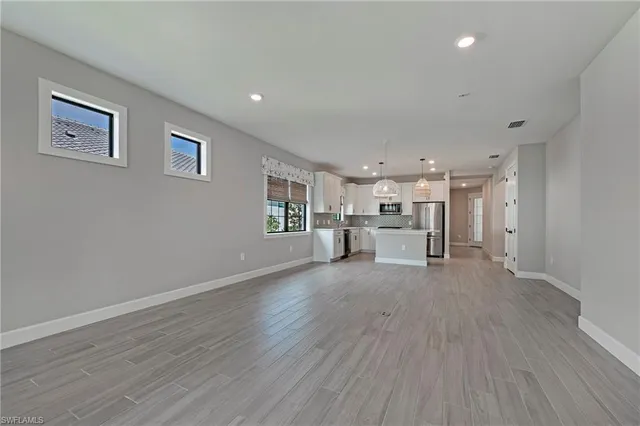 a view of a livingroom with wooden floor and windows