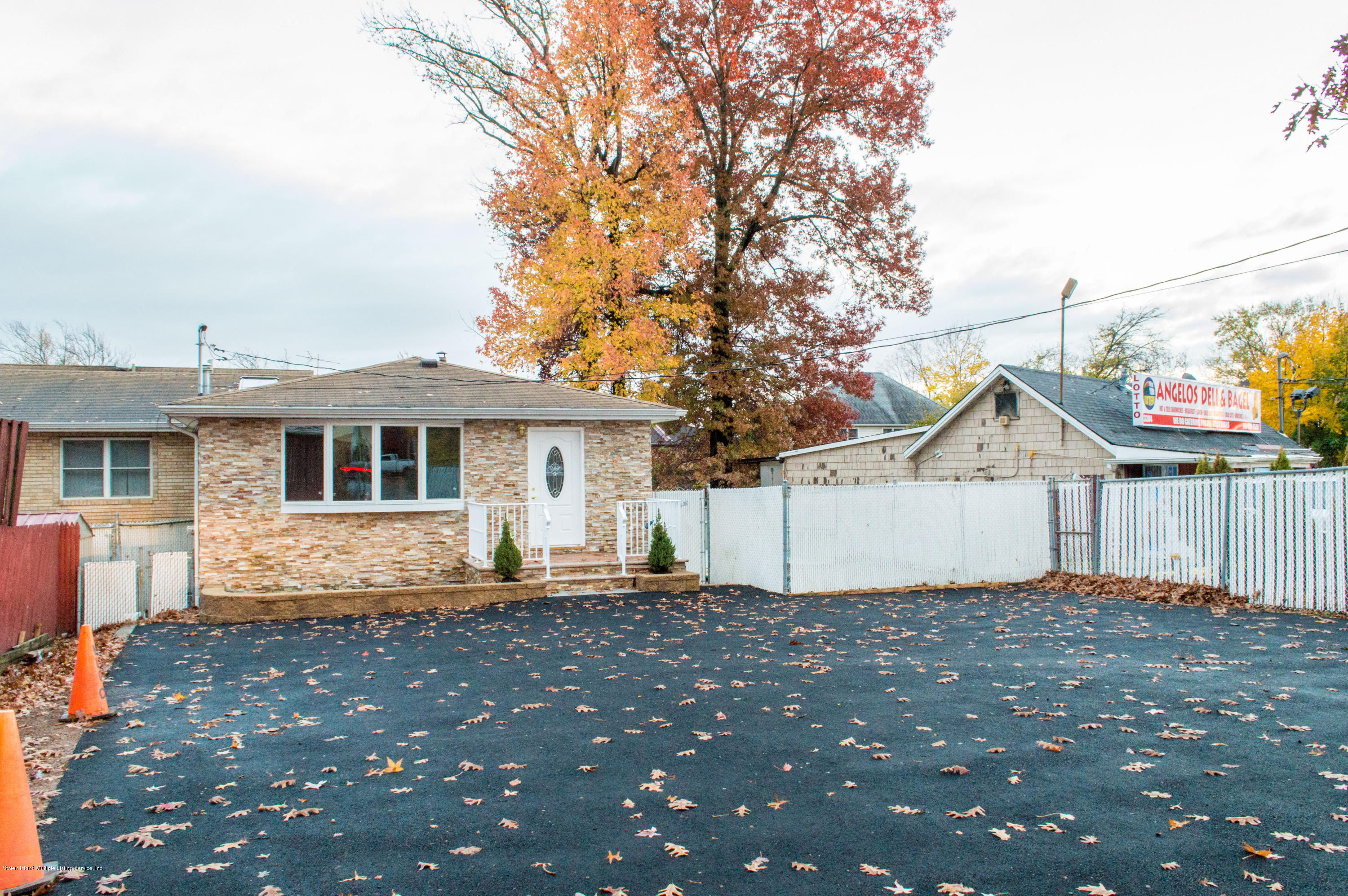 3298 Amboy Road Staten Island, NY 10306 - Photo 3 of 16 a front view of a house with a yard