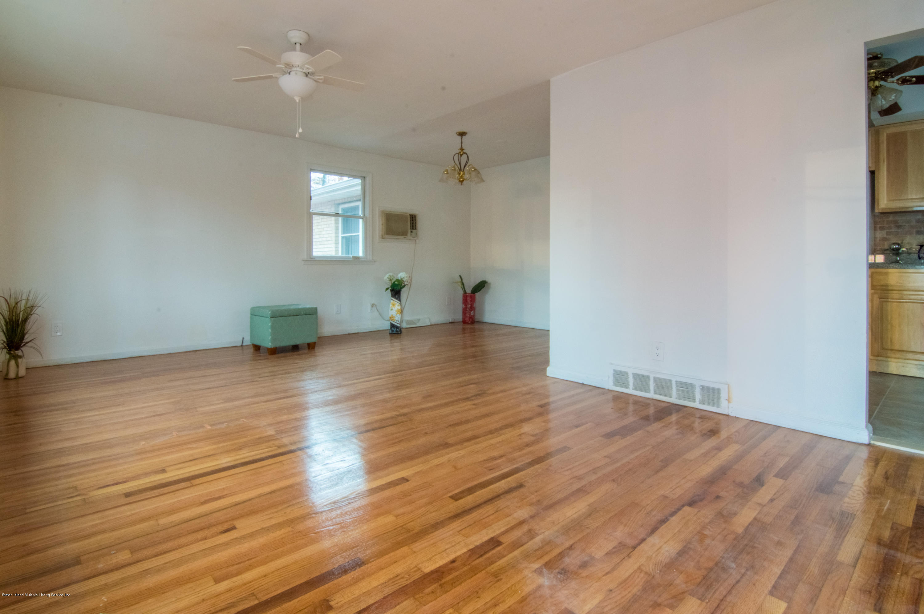 3298 Amboy Road Staten Island, NY 10306 - Photo 4 of 16 wooden floor in an empty room with a window