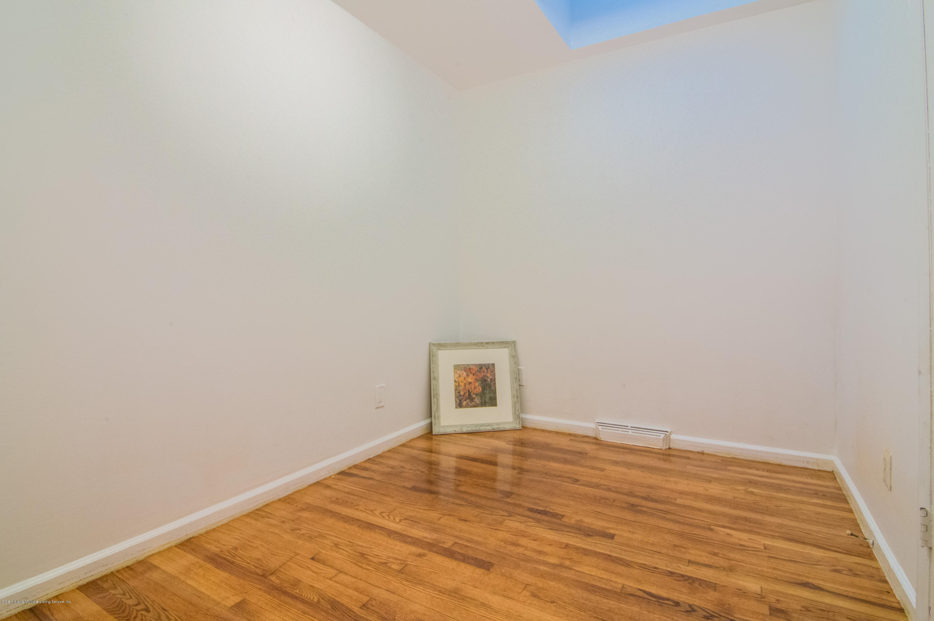 3298 Amboy Road Staten Island, NY 10306 - Photo 8 of 16 a view of empty room with wooden floor