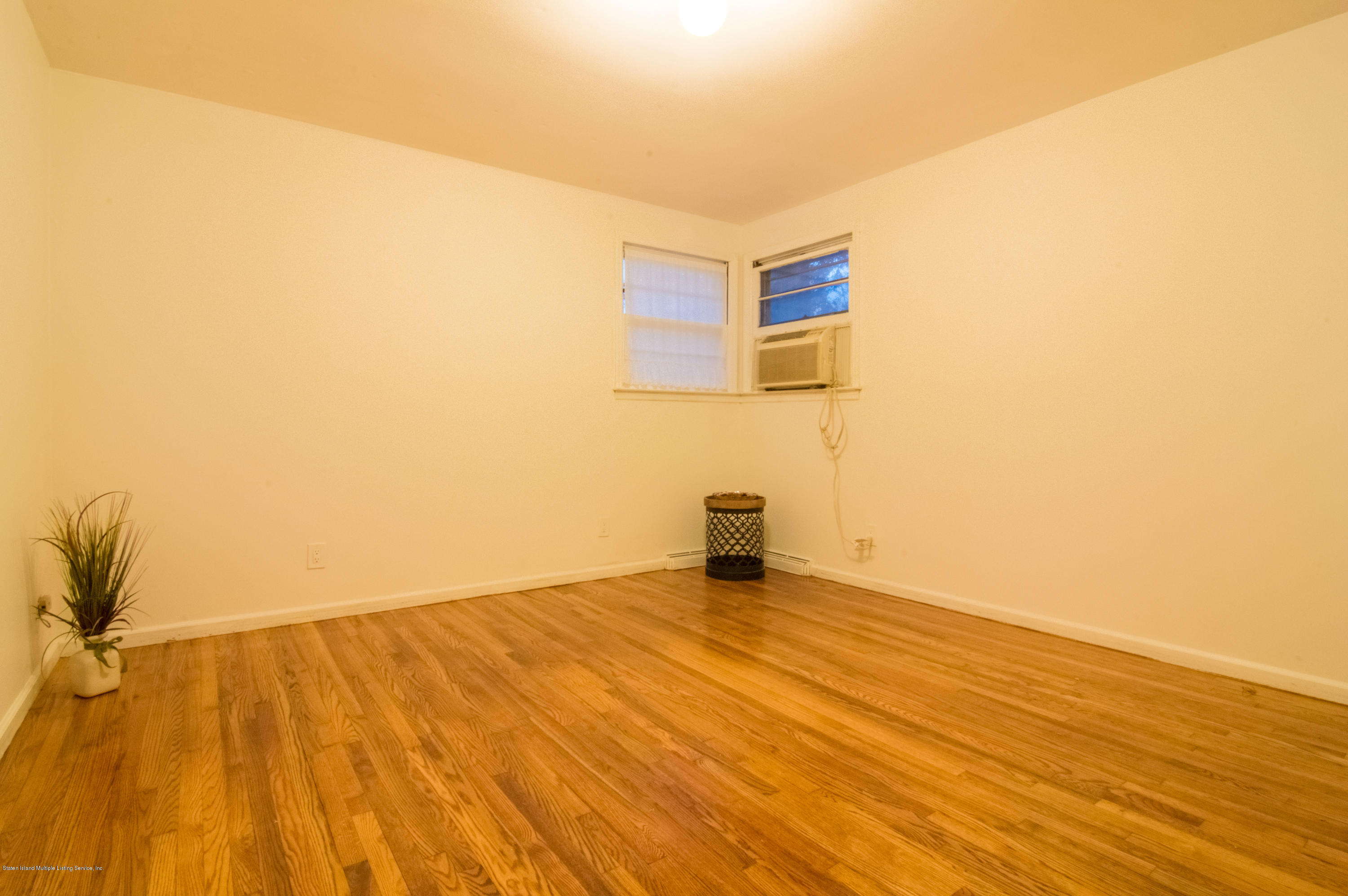 3298 Amboy Road Staten Island, NY 10306 - Photo 10 of 16 a view of an empty room and wooden floor