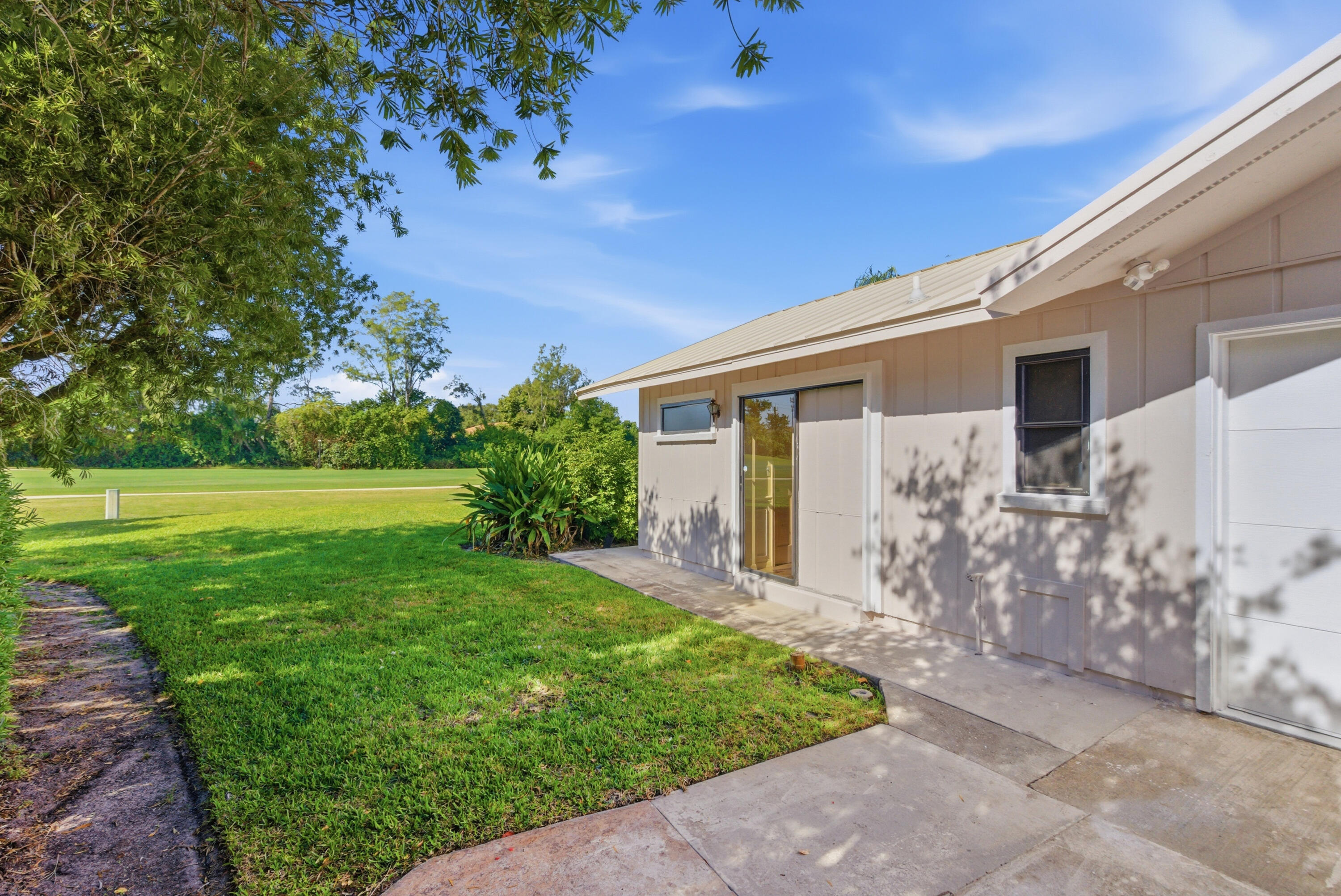 5151 Southeast Burning Tree Circle Stuart, FL 34997 - Photo 53 of 74 a front view of a house with garden