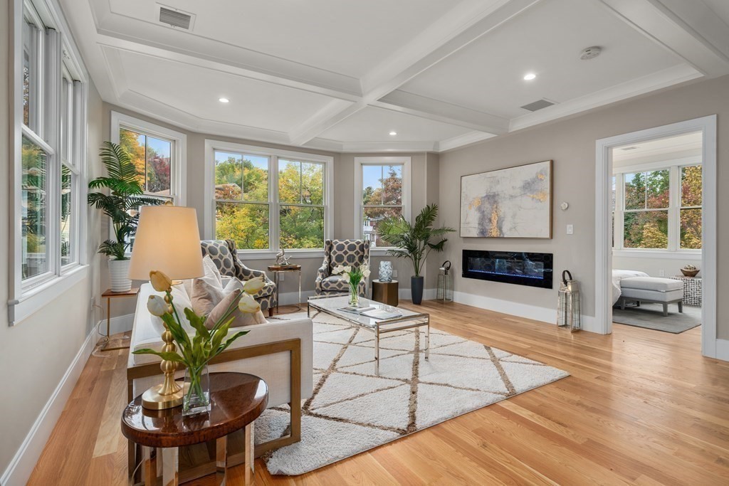 96 Verndale Street, Unit 2 Brookline, MA 02446 - Photo 13 of 31 a living room with furniture dining table and a fireplace
