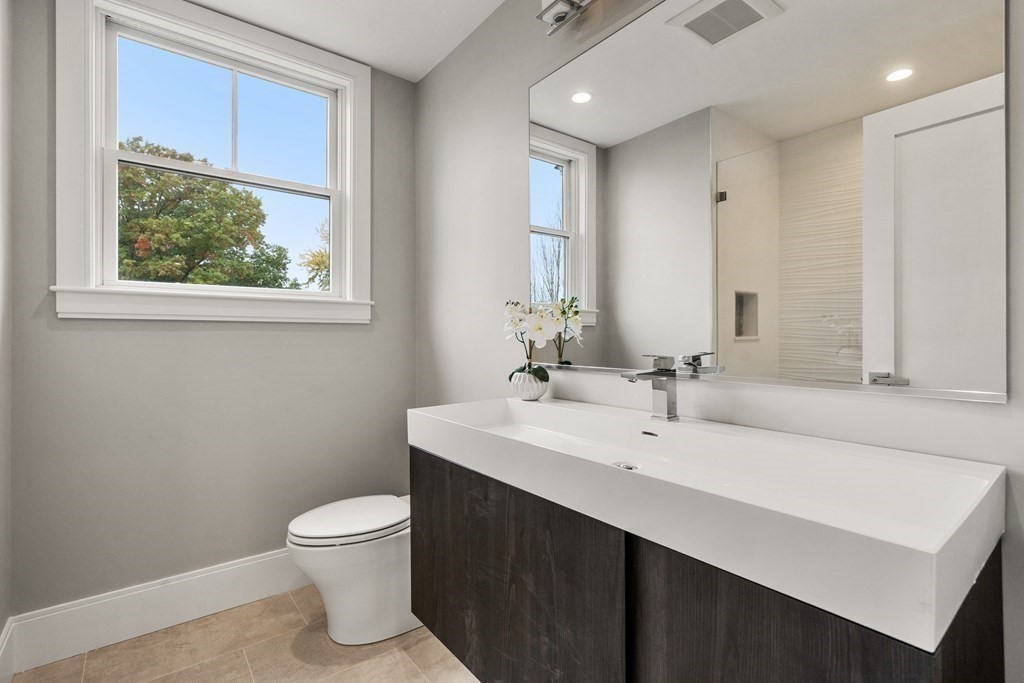 96 Verndale Street, Unit 2 Brookline, MA 02446 - Photo 18 of 31 a bathroom with a sink a toilet and a mirror