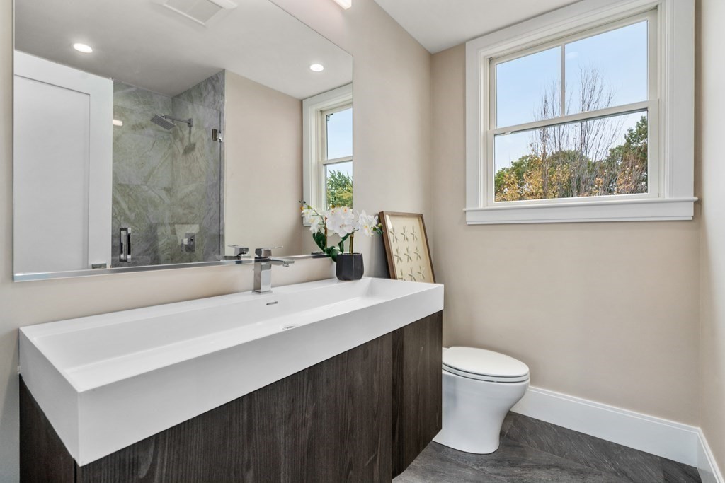 96 Verndale Street, Unit 2 Brookline, MA 02446 - Photo 22 of 31 a bathroom with a sink vanity mirror and toilet