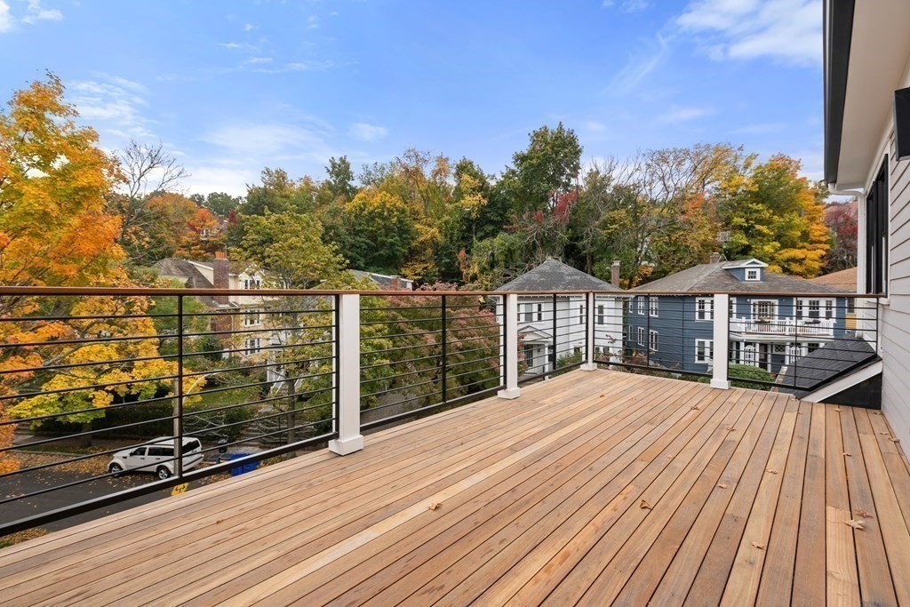 96 Verndale Street, Unit 2 Brookline, MA 02446 - Photo 27 of 31 a view of roof deck with wooden floor and city view