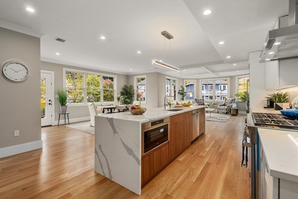 96 Verndale Street, Unit 2 Brookline, MA 02446 - Photo 6 of 31 a kitchen with stainless steel appliances granite countertop lots of counter top space and wooden floor