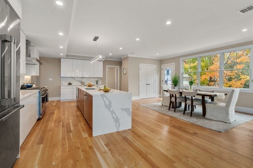96 Verndale Street, Unit 2 Brookline, MA 02446 - Photo 8 of 31 a living room with stainless steel appliances furniture wooden floor and a large window