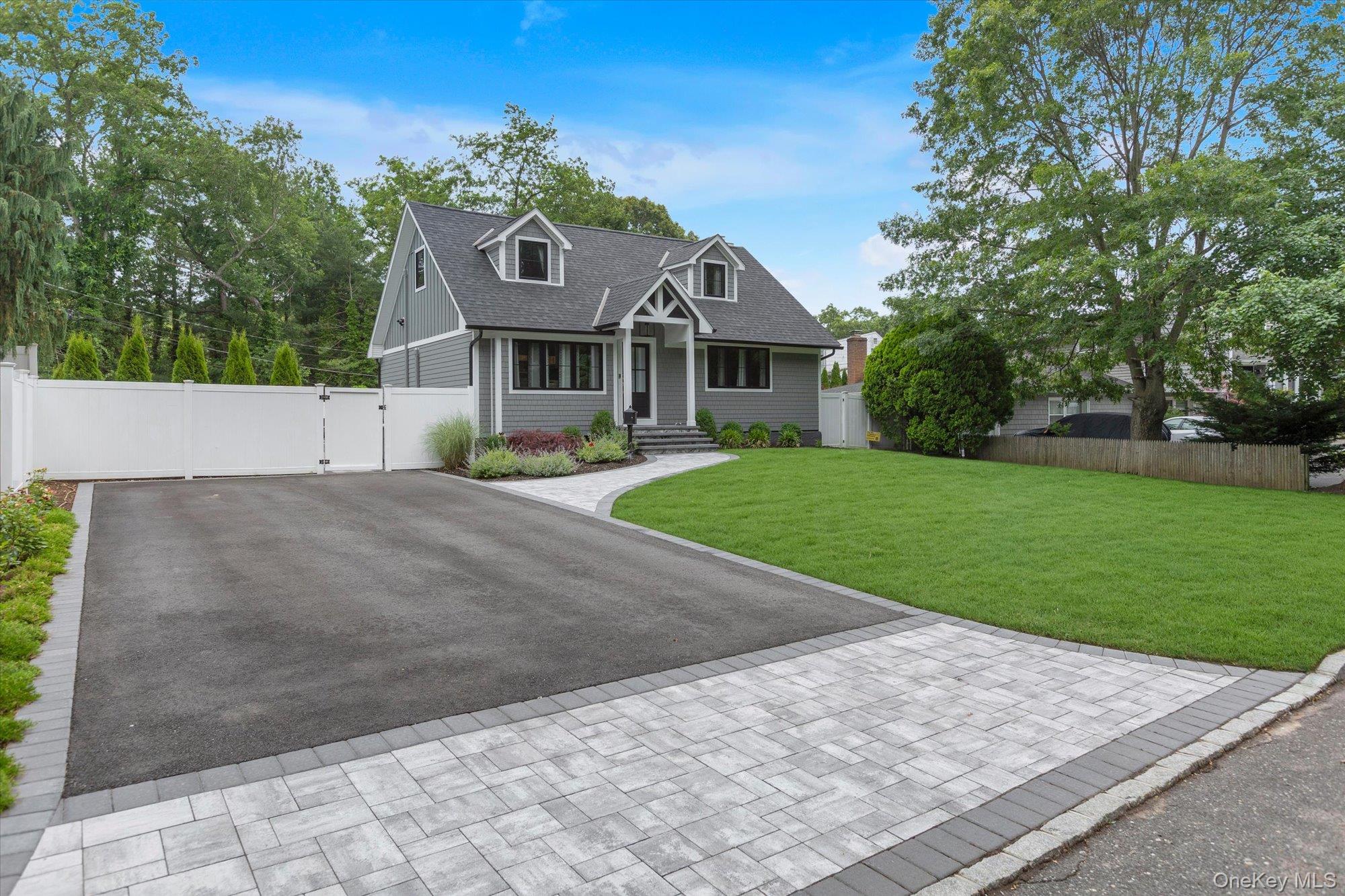 31 Apple Lane Commack, NY 11725 - Photo 24 of 28 Front lawn with driveway and privacy fence.