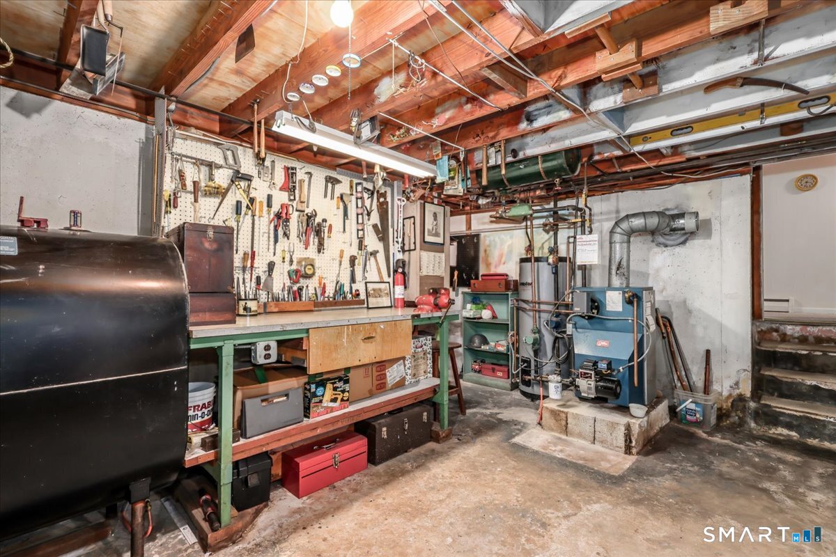 75 Centerbrook Road Fairfield, CT 06824 - Photo 30 of 39 Workbench, utilities, oil tank in unfinished basement. Full space of unfinished basement is 18' x 25'