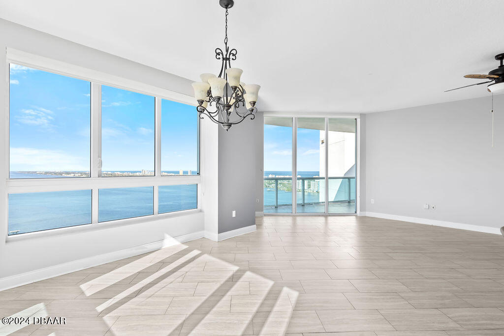 241 Riverside Drive, Unit 2610 Daytona Beach, FL 32117 - Photo 6 of 31 a view of an empty room with wooden floor and a window