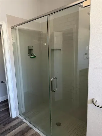 a bathroom with a glass shower door