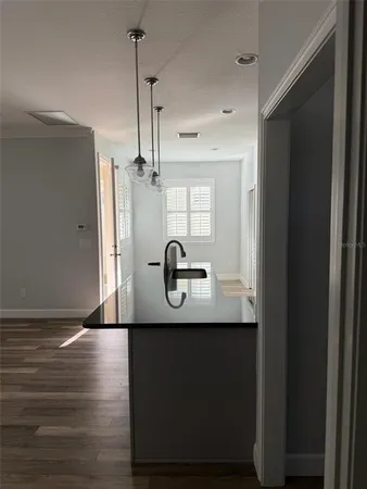 a bathroom with granite countertop a sink and a mirror