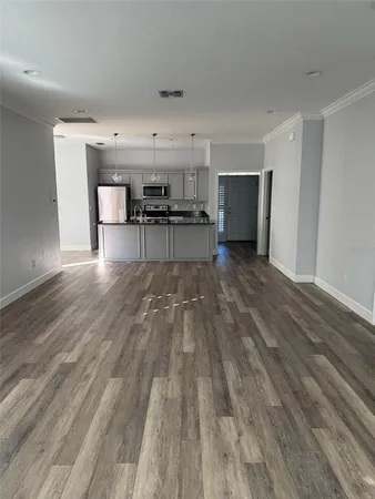 a view of a workspace with furniture and wooden floor