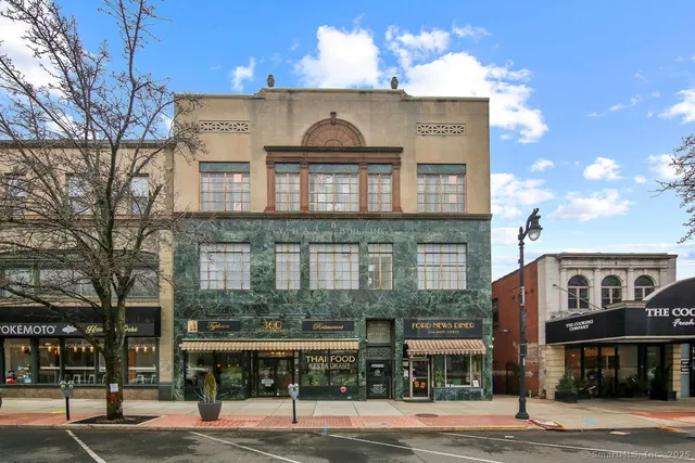 a view of a brick building next to a road