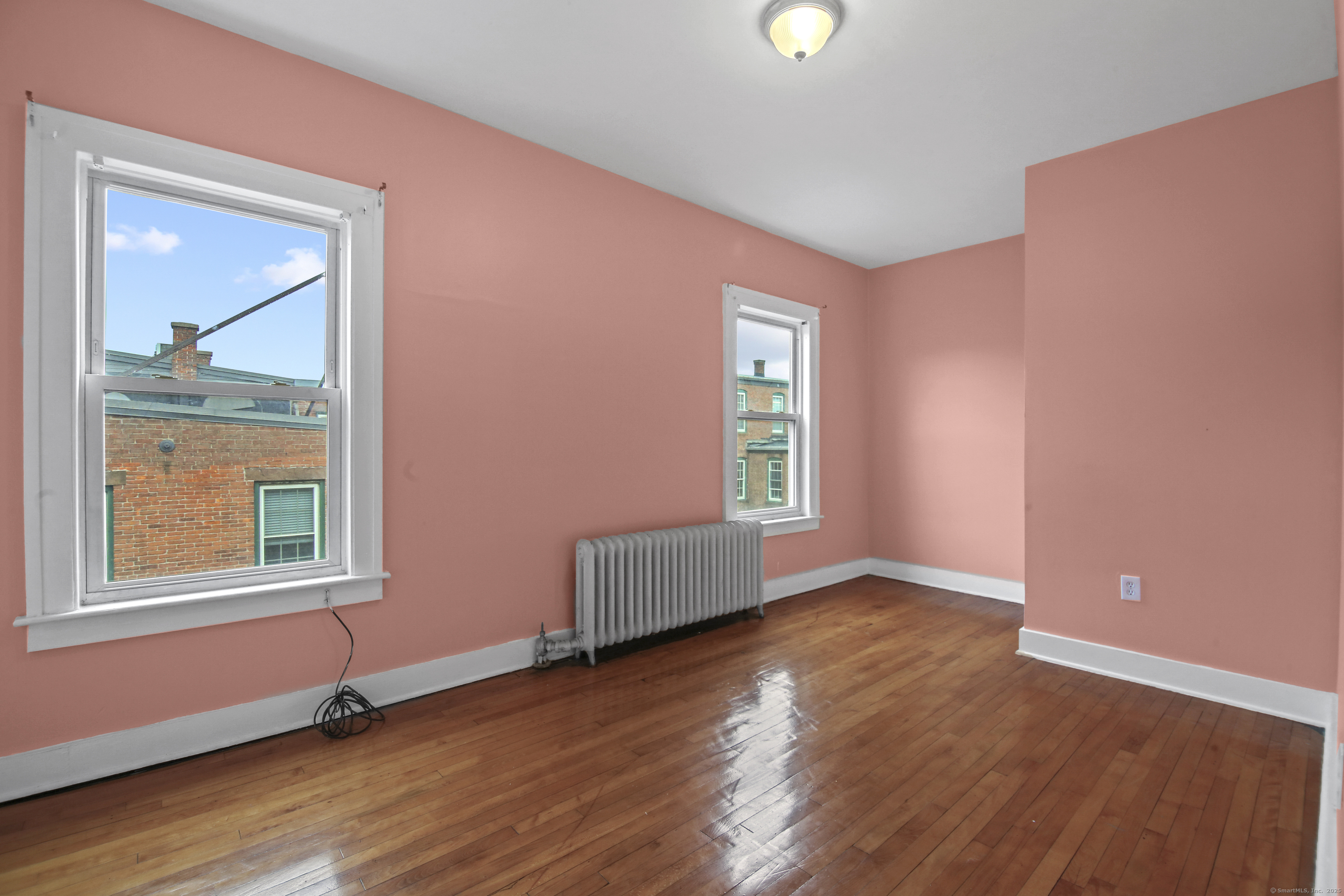 360 Main Street, Unit 3B Middletown, CT 06457 - Photo 11 of 24 an empty room with window and wooden floor