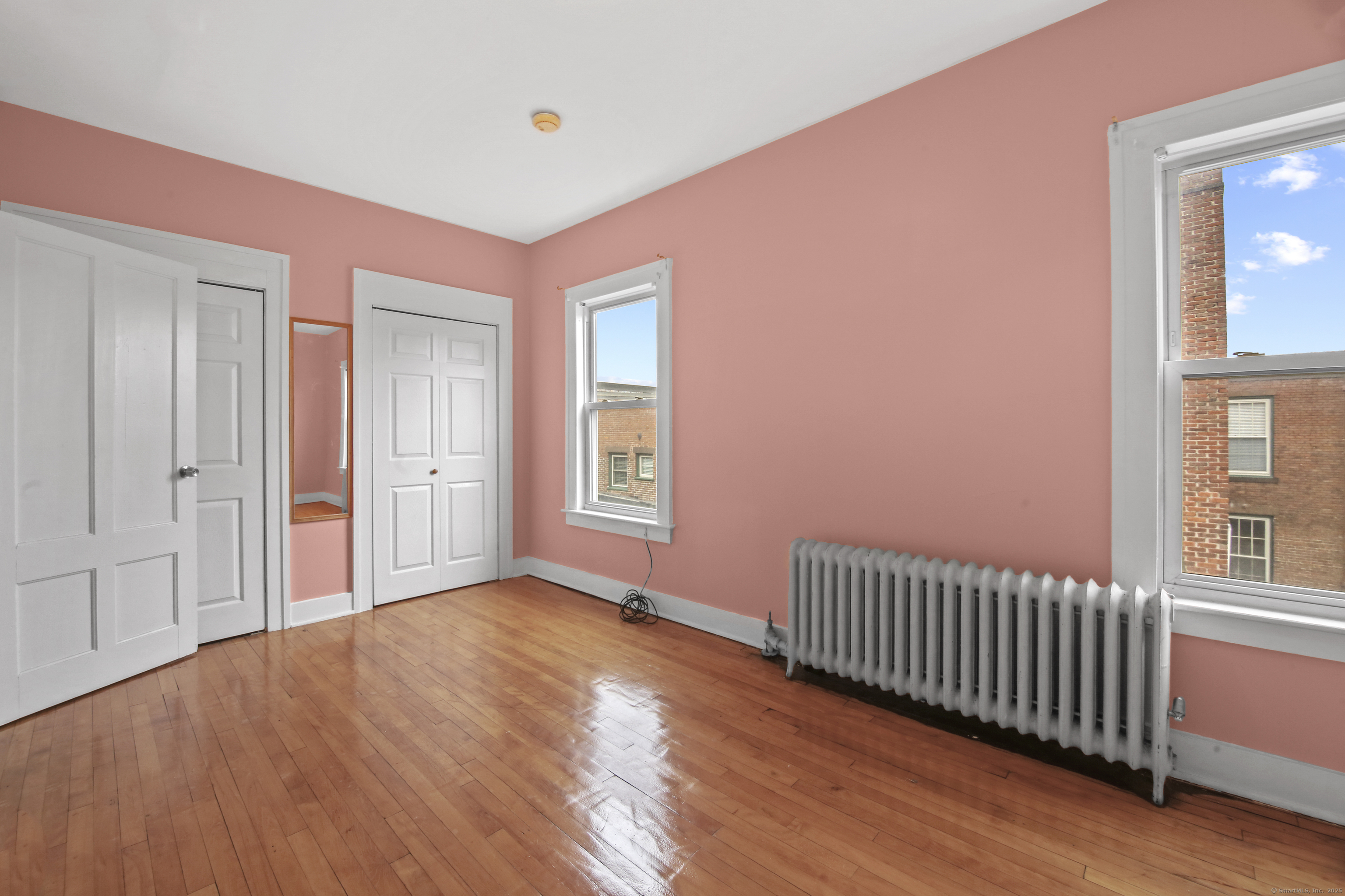 360 Main Street, Unit 3B Middletown, CT 06457 - Photo 12 of 24 a view of an empty room with wooden floor and a window