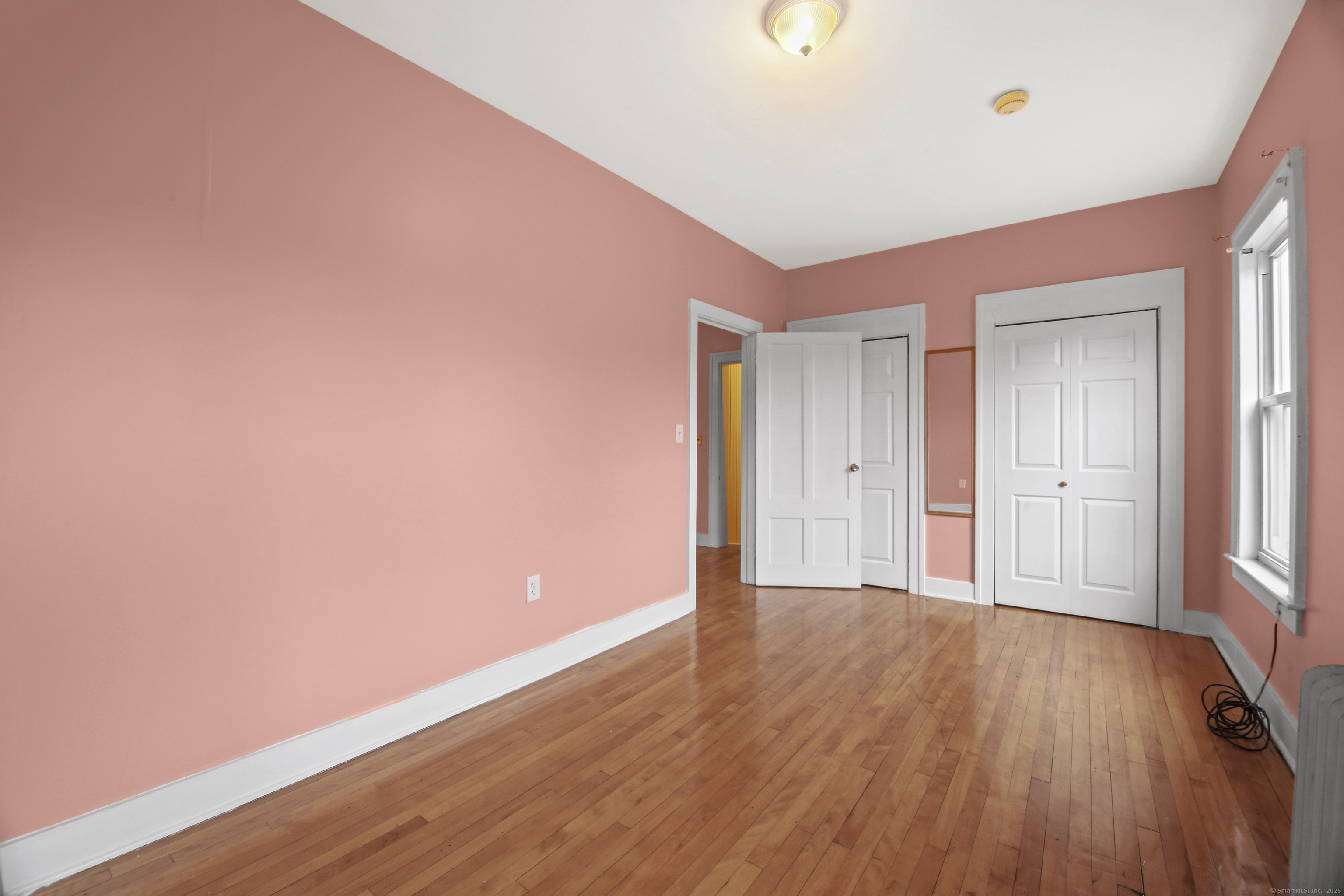 360 Main Street, Unit 3B Middletown, CT 06457 - Photo 13 of 24 a view of an empty room with wooden floor